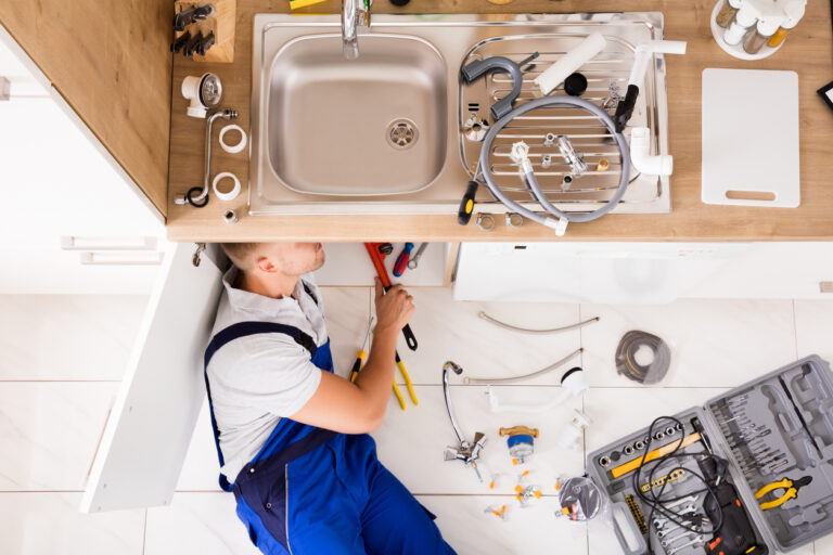Home plumbing pipes and drain lines under sink