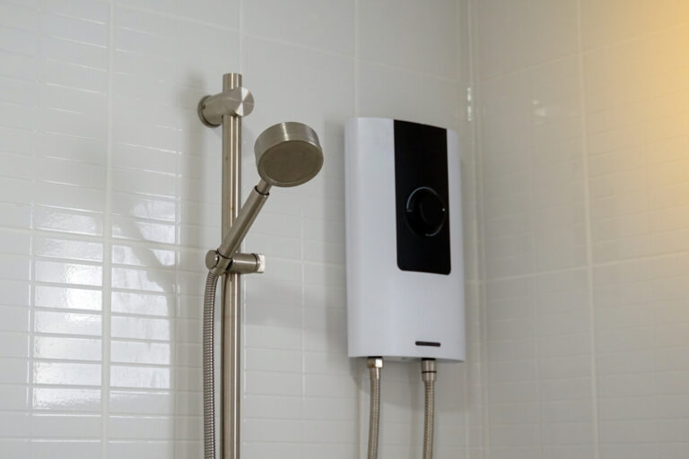 Tankless water heater in a tiled bathroom, showing space-saving design and energy-efficient setup.