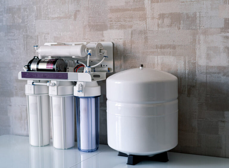 Technician performing professional water treatment services with system installation in a Houston home