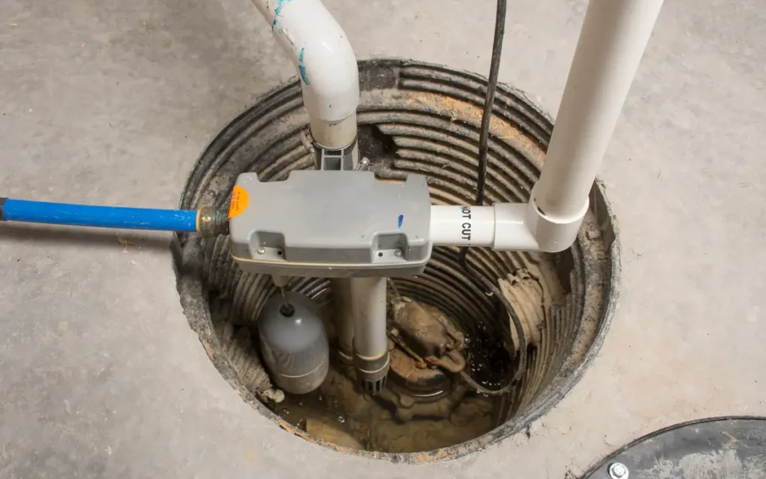 Professional sump pump installation with pump and drainage pipes inside a basement pit for home water protection.