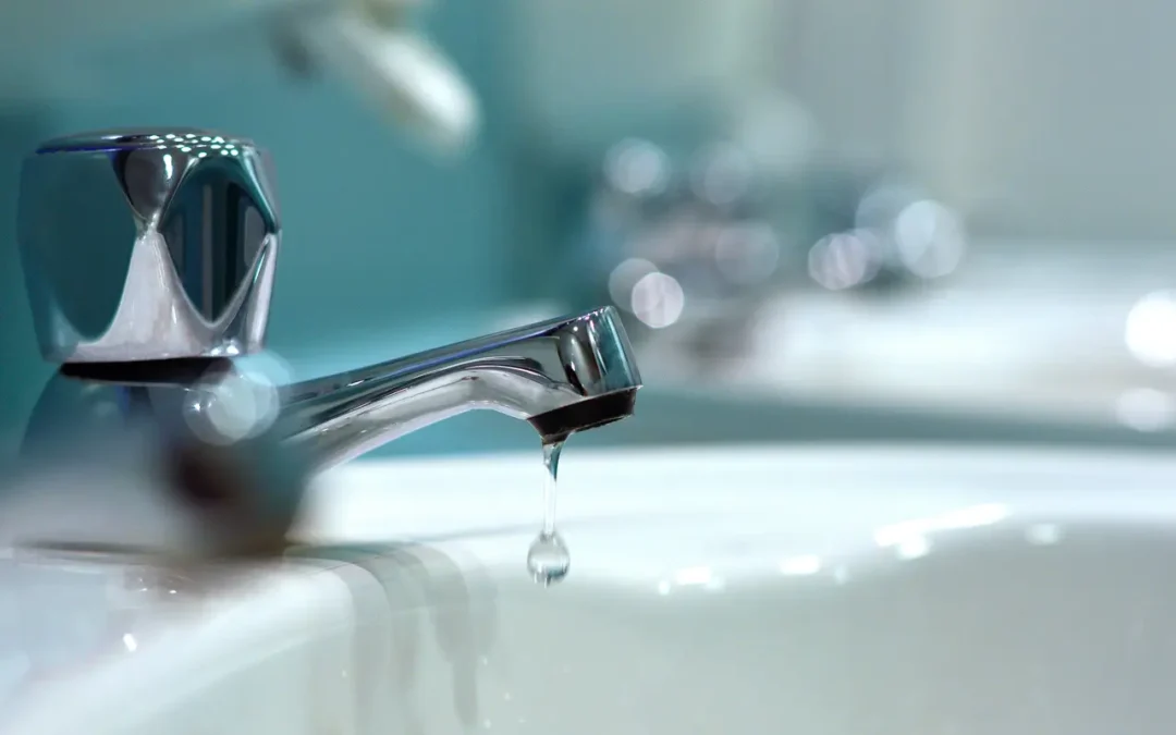 Close-up of a dripping chrome faucet representing urgent plumbing repair and risks of ignoring small leaks in Texas homes.