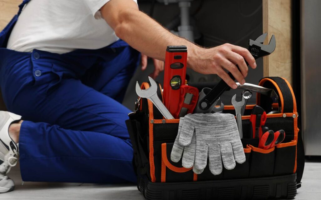 Champion Plumbing Services plumber preparing tools for Cypress plumbing service